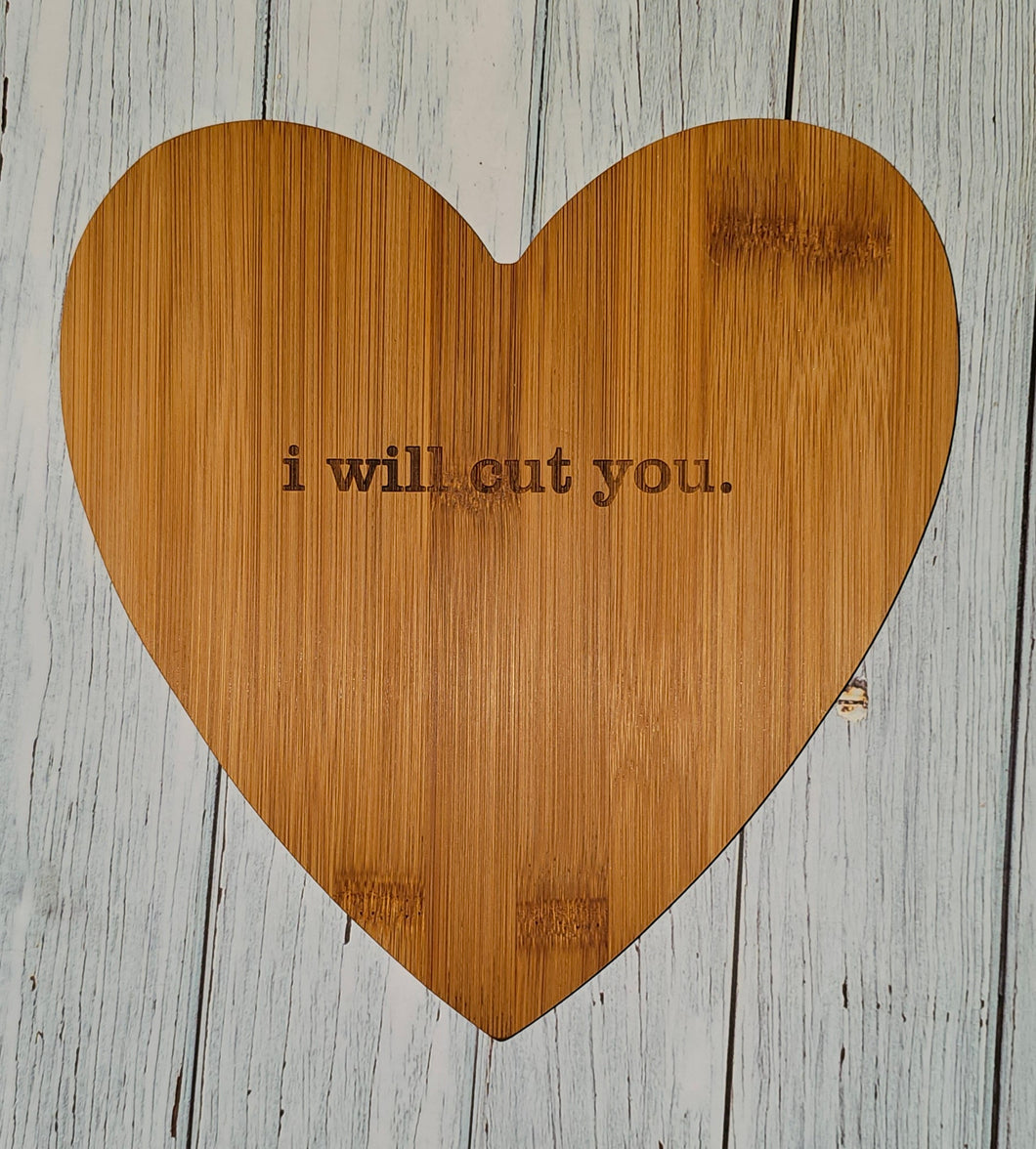 i will cut you. heart-shaped cutting board